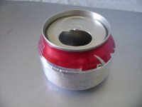 A completed simmer ring rests on a completed soda can stove